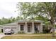 Charming single-story home with columns, a well-manicured lawn, and a three-car garage at 10292 Kristen Park Dr, Orlando, FL 32832