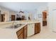 This kitchen features dark wood cabinets, neutral countertops, tile flooring, and an island overlooking the living areas at 10292 Kristen Park Dr, Orlando, FL 32832