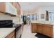 Traditional kitchen with stainless steel sink and black appliances and tile floors at 10292 Kristen Park Dr, Orlando, FL 32832