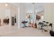 Open living area with tile and carpet flooring, featuring multiple instruments and an open floor plan at 10292 Kristen Park Dr, Orlando, FL 32832