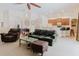 An open-concept living room offers a cozy setting with comfortable seating and views of the adjacent kitchen at 10292 Kristen Park Dr, Orlando, FL 32832