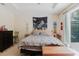 Bright and airy main bedroom featuring tray ceiling and sliding glass doors to lanai at 10292 Kristen Park Dr, Orlando, FL 32832