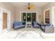 Covered patio features comfortable seating, fan, and tiled flooring with access to the backyard at 10292 Kristen Park Dr, Orlando, FL 32832