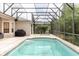 A screened-in pool with tiled coping and stairs, surrounded by a patio and tropical foliage at 10292 Kristen Park Dr, Orlando, FL 32832