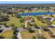 Stunning aerial view of a grand estate home with lake and expansive manicured lawn at 12329 Sw 140Th Loop, Dunnellon, FL 34432