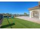 Expansive backyard with a fire pit, seating, lush green lawn, and a tranquil lake view at 12329 Sw 140Th Loop, Dunnellon, FL 34432