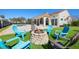 A charming backyard with a stone fire pit and colorful chairs set for entertaining guests at 12329 Sw 140Th Loop, Dunnellon, FL 34432
