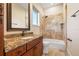 Bathroom featuring granite vanity, wood cabinets, toilet, and tub with tile at 12329 Sw 140Th Loop, Dunnellon, FL 34432