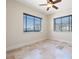 Bedroom featuring neutral walls, stone flooring and natural light from two windows at 12329 Sw 140Th Loop, Dunnellon, FL 34432