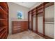 Spacious walk-in closet with custom wood shelving, drawers and stone flooring at 12329 Sw 140Th Loop, Dunnellon, FL 34432