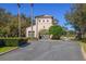 Entrance gate to community featuring mature landscaping and guard house at 12329 Sw 140Th Loop, Dunnellon, FL 34432