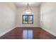 Bright dining room with wood floors and a large arched window for plenty of natural light at 12329 Sw 140Th Loop, Dunnellon, FL 34432