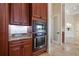 Gourmet kitchen features a built-in oven and microwave, complemented by custom wood cabinetry at 12329 Sw 140Th Loop, Dunnellon, FL 34432