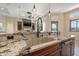 Open kitchen view featuring a large island with granite countertops and stainless steel appliances at 12329 Sw 140Th Loop, Dunnellon, FL 34432