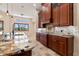 Gourmet kitchen featuring granite countertops, custom cabinetry, and tile backsplash at 12329 Sw 140Th Loop, Dunnellon, FL 34432