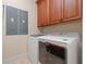 A well-equipped laundry room includes a modern, white Maytag washer and dryer beneath ample cabinet storage at 12329 Sw 140Th Loop, Dunnellon, FL 34432