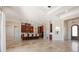 Open floor plan with kitchen island and travertine floors at 12329 Sw 140Th Loop, Dunnellon, FL 34432