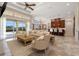 Bright living room open to kitchen with travertine floors, large windows and neutral decor at 12329 Sw 140Th Loop, Dunnellon, FL 34432