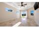 Spacious main bedroom with tray ceiling, recessed lighting, and glass doors to the lanai at 12329 Sw 140Th Loop, Dunnellon, FL 34432