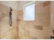 Shower room featuring neutral, tile walls and a frosted window for natural light at 12329 Sw 140Th Loop, Dunnellon, FL 34432