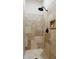 Shower with natural stone tile, a shower niche and a modern shower head at 12329 Sw 140Th Loop, Dunnellon, FL 34432