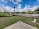 Wide open backyard with lush grass, mature trees, and privacy fencing offering space for gardening, and outdoor enjoyment at 2625 Williston Dr, Lakeland, FL 33801