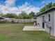 Fenced backyard with a concrete patio, lush grass, and tidy landscaping, ideal for relaxation and recreation at 2625 Williston Dr, Lakeland, FL 33801