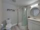 Well-lit bathroom with a stand-up shower, vanity with a sink, and a toilet; all complemented by neutral finishes at 2625 Williston Dr, Lakeland, FL 33801
