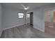 Bright bedroom boasting wood-look floors, a ceiling fan, closet with mirror doors, and a neutral color palette at 2625 Williston Dr, Lakeland, FL 33801