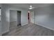 Light-filled bedroom with wood-look floors, a ceiling fan, a closet with mirror doors, and neutral-toned walls at 2625 Williston Dr, Lakeland, FL 33801