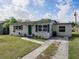 Exterior of home showing tidy landscaping, a green front door, and a double driveway at 2625 Williston Dr, Lakeland, FL 33801