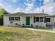 Charming home features a well-manicured lawn, tidy landscaping, and a bright green front door at 2625 Williston Dr, Lakeland, FL 33801