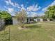 Exterior home with nice green lawn and mature tree in a well-maintained front yard at 2625 Williston Dr, Lakeland, FL 33801