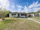 Quaint single-story home with fresh exterior paint, neat landscaping, and healthy green grass at 2625 Williston Dr, Lakeland, FL 33801