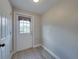 Bright hallway showcasing a white exterior door, light gray walls, and clean flooring, providing a welcoming entrance at 2625 Williston Dr, Lakeland, FL 33801