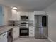 Updated kitchen featuring stainless steel appliances, granite counters, and white cabinets at 2625 Williston Dr, Lakeland, FL 33801
