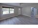 Living room with wood-look flooring, a front door with decorative glass, and neutral paint at 2625 Williston Dr, Lakeland, FL 33801