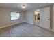 Bedroom featuring new floors and a hallway leading to the kitchen at 2625 Williston Dr, Lakeland, FL 33801
