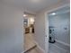 Open view through the hallway to a modern kitchen with stainless steel appliances and white cabinets at 2625 Williston Dr, Lakeland, FL 33801