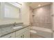 Granite vanity and tiled tub/shower with a showerhead and handy soap shelf at 30505 Island Club Dr., Deer Island, FL 32778