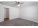 Well-lit bedroom with a ceiling fan, carpeted floor, closet, and bright trim at 30505 Island Club Dr., Deer Island, FL 32778