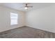 Bright bedroom featuring a ceiling fan and natural light streaming through the window at 30505 Island Club Dr., Deer Island, FL 32778