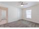 Neutral bedroom with ceiling fan, closet, and window bringing in natural light at 30505 Island Club Dr., Deer Island, FL 32778