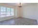 Bright dining room featuring neutral walls, tile flooring, large window, and chandelier at 30505 Island Club Dr., Deer Island, FL 32778