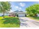 Charming single-story home with a well-manicured lawn and a two-car garage, enhancing curb appeal at 30505 Island Club Dr., Deer Island, FL 32778