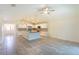 Bright open kitchen featuring granite countertops, stainless steel appliances, and tiled floors at 30505 Island Club Dr., Deer Island, FL 32778