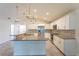 Bright open kitchen featuring granite countertops, stainless steel appliances, and tiled floors at 30505 Island Club Dr., Deer Island, FL 32778