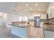 Bright open kitchen featuring granite countertops, stainless steel appliances, and tiled floors at 30505 Island Club Dr., Deer Island, FL 32778