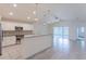 Bright open kitchen featuring granite countertops, stainless steel appliances, and tiled floors at 30505 Island Club Dr., Deer Island, FL 32778