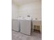 Functional laundry room equipped with a washer, dryer, sink, and overhead storage shelf at 30505 Island Club Dr., Deer Island, FL 32778